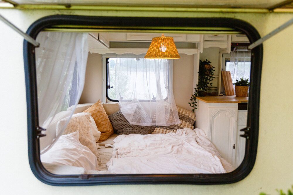 A View Of A Bed In A Camper Through A Window — Coastal Upholstery In Berkeley Vale, NSW