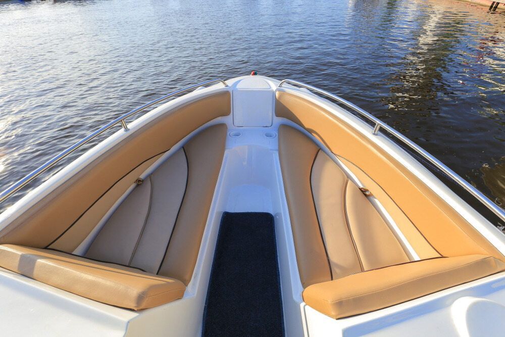 A White Boat With Tan Seats Is In The Water — Coastal Upholstery In Berkeley Vale, NSW