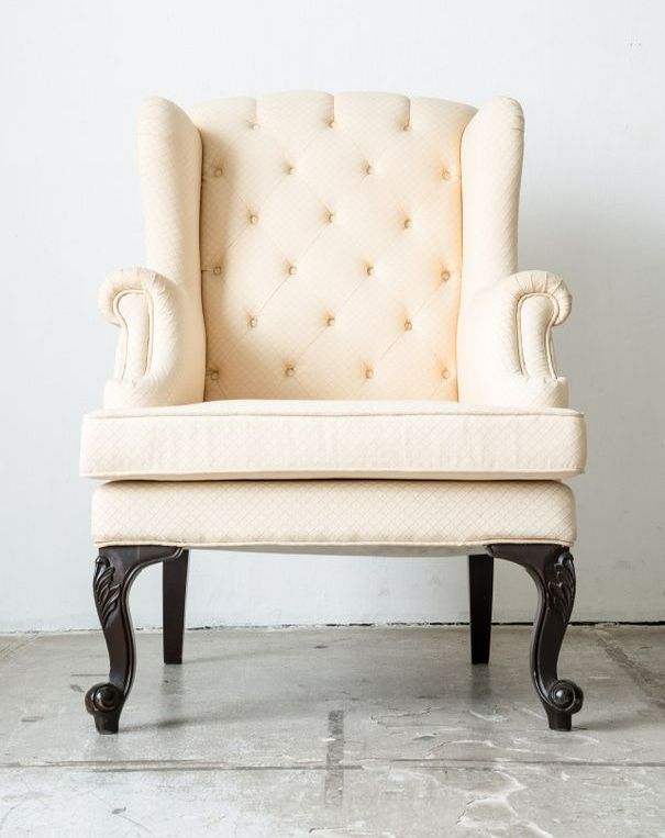 A White Chair With Black Legs Is Sitting On A Concrete Floor — Coastal Upholstery In Berkeley Vale, NSW