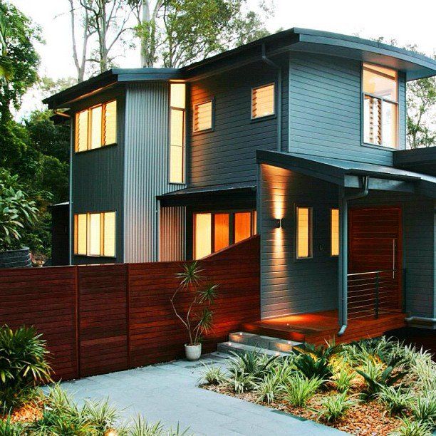 an image of a beautiful home with a wood fence