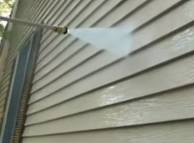 siding getting pressure cleaned