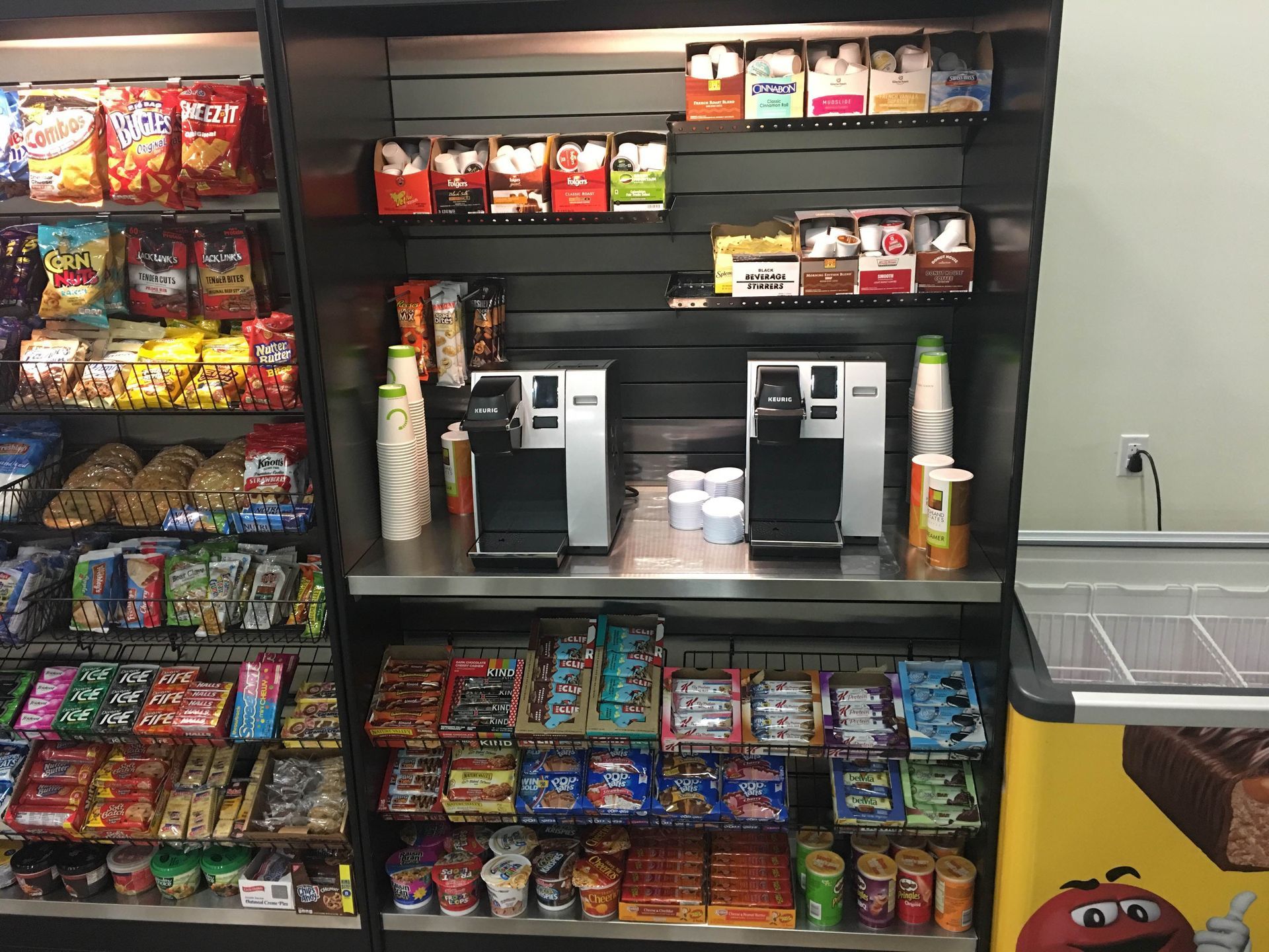 A vending machine with a m & ms sign on it