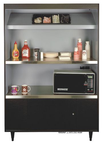 A shelf with a microwave and condiments on it