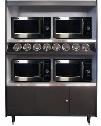 A shelf with four microwaves and plates on it.