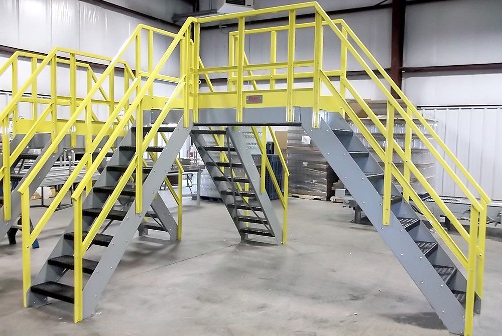 A set of stairs with a yellow railing in a building