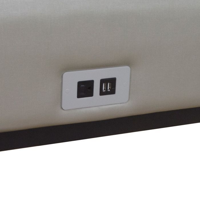 A close up of a power outlet on a couch