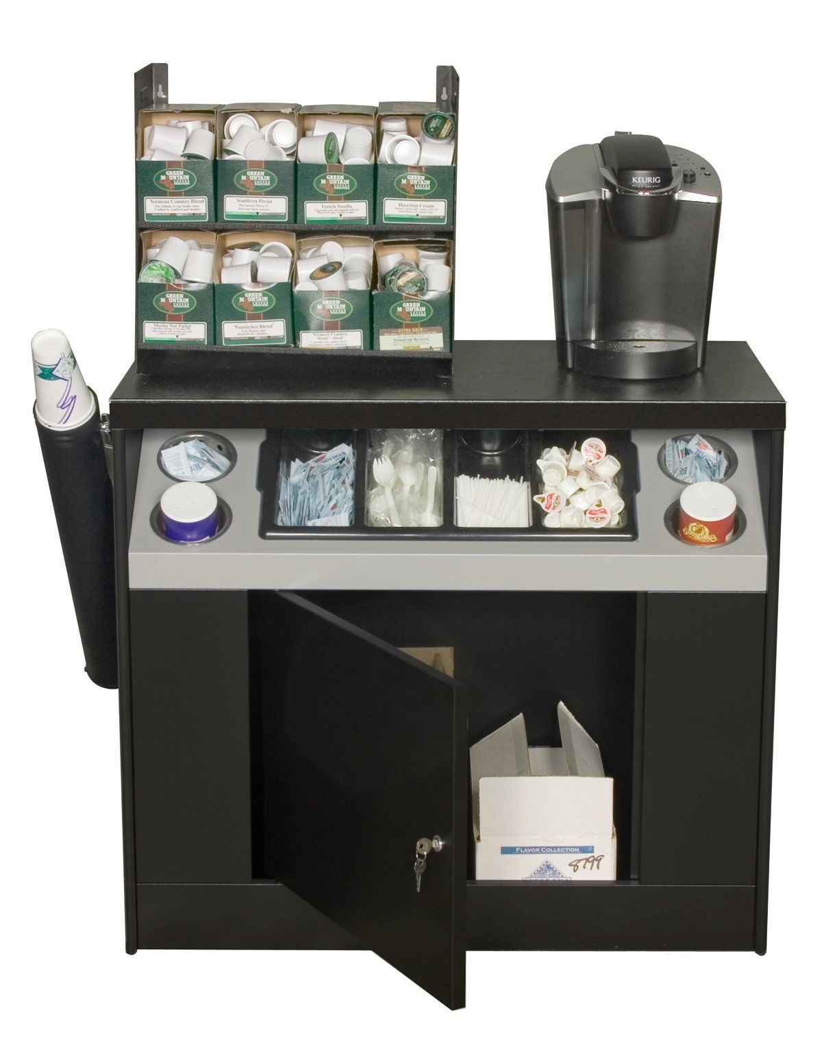 A coffee station with a keurig coffee maker and cup holders.