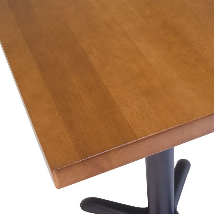 A wooden table with a black base on a white background
