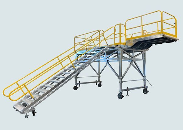 A metal platform with stairs and a yellow railing