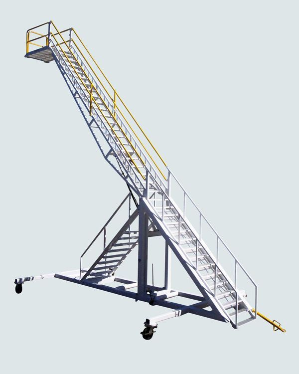 A metal staircase with a yellow railing on a white background