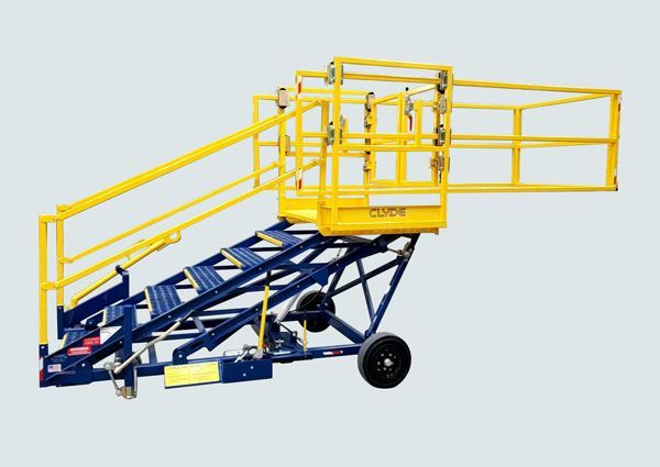 A yellow and blue staircase with wheels and a yellow railing.