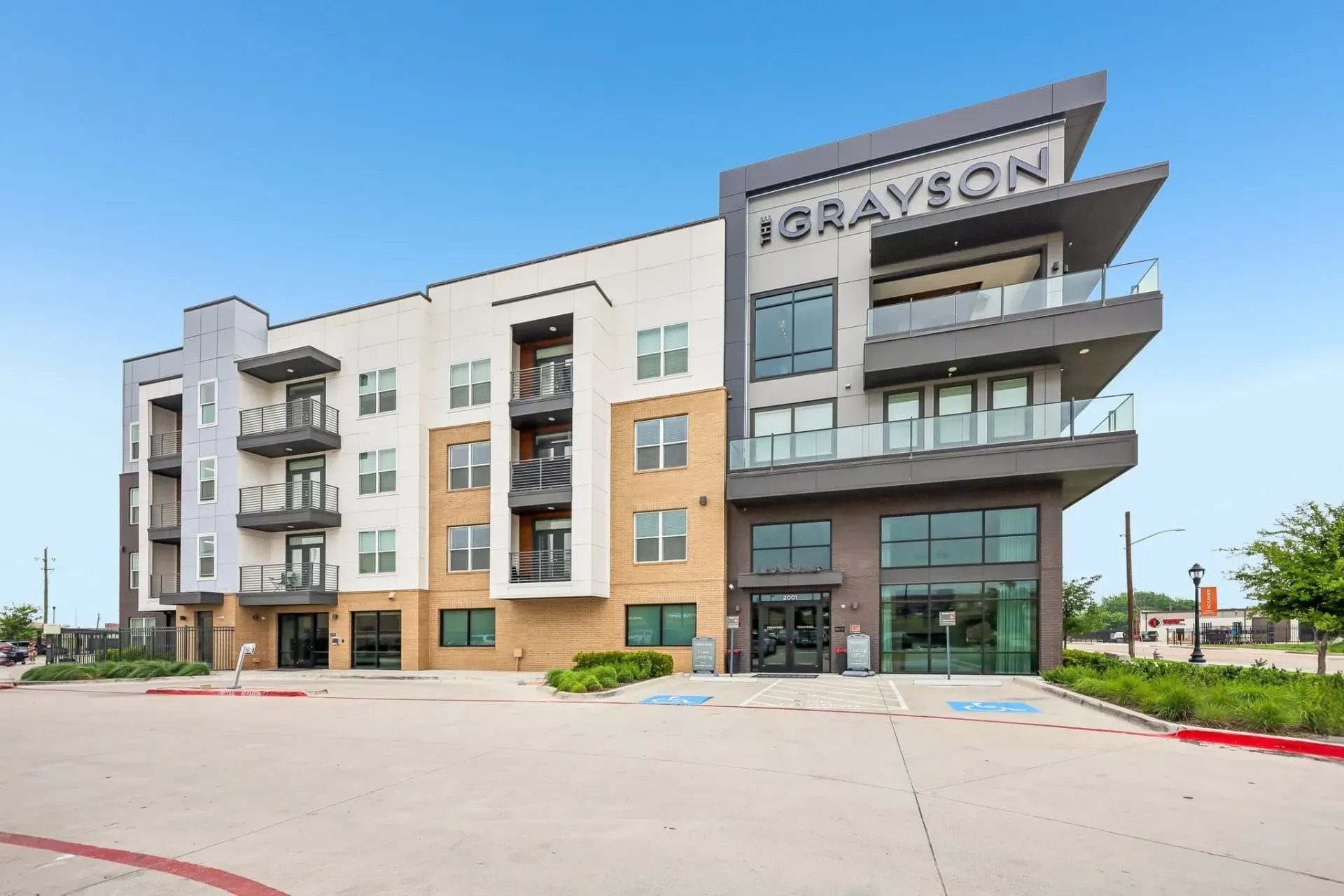 The Grayson apartment building exterior with modern architecture and balconies at The Grayson apartments in Fort Worth, TX.. 