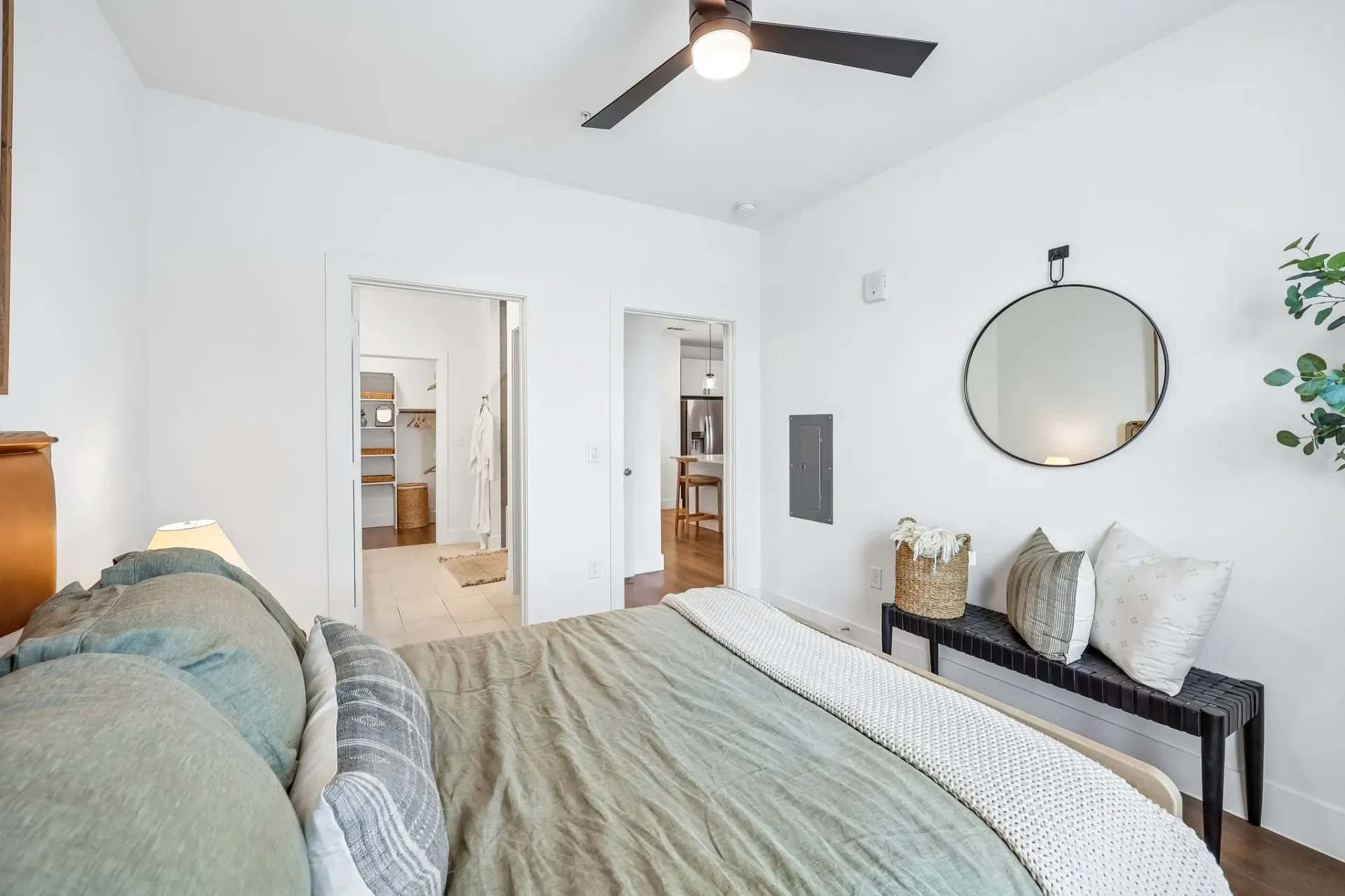 Bedroom with a bed, walk-in closet, and doorway to kitchen at The Grayson.
