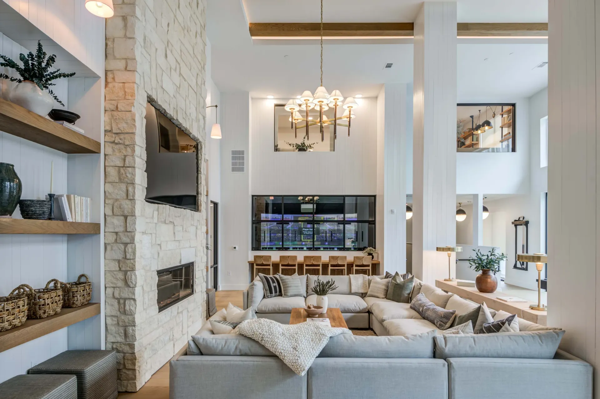Spacious communal living area with a large sectional sofa, fireplace, and modern decor at The Grayson apartments in Fort Worth, TX..