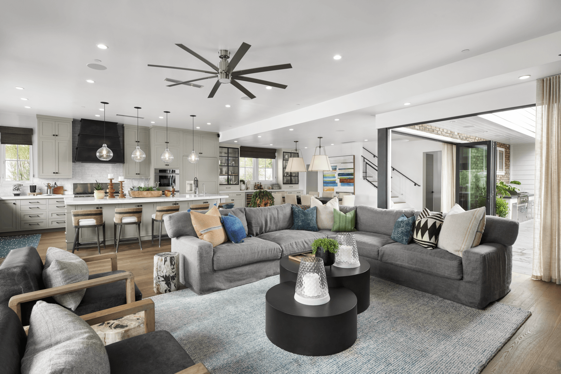 A living room filled with furniture and a ceiling fan.