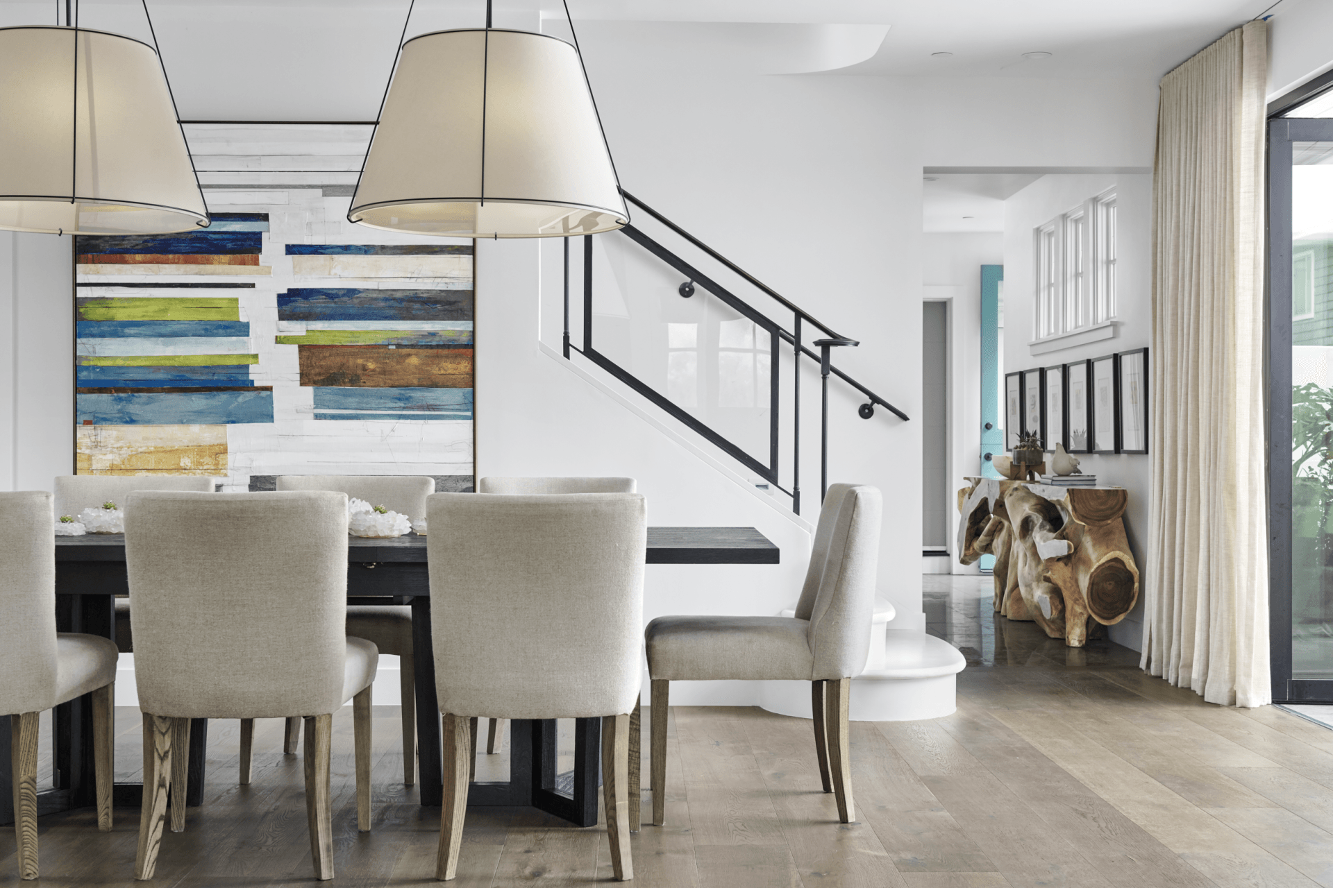 A dining room with a table and chairs and stairs