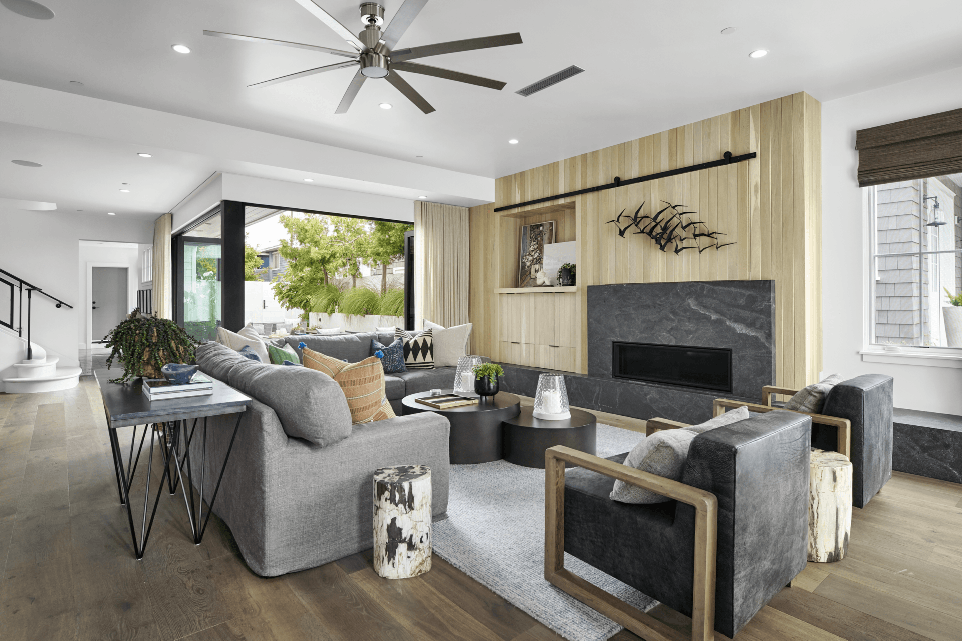 A living room filled with furniture and a ceiling fan.