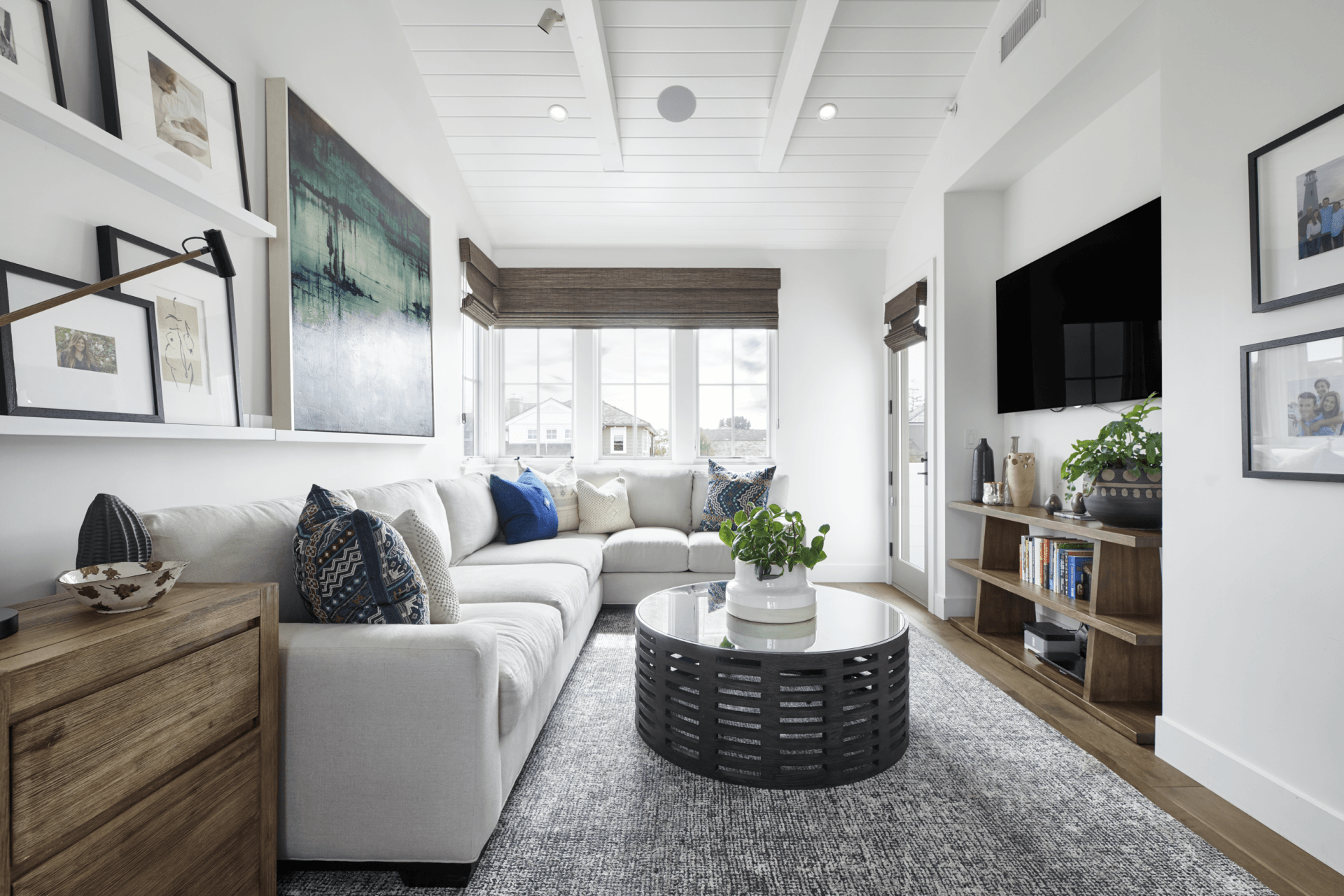 A living room with a couch , coffee table , and television.