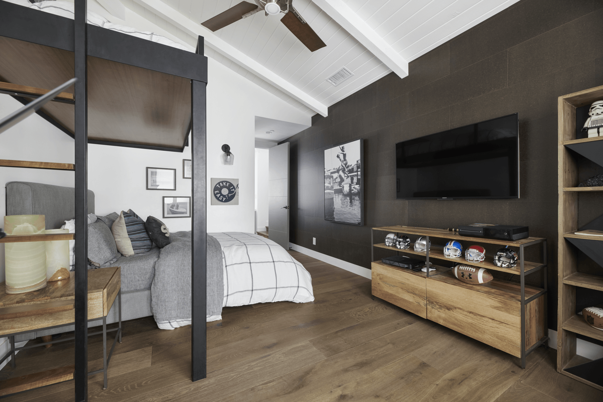 A bedroom with a bunk bed and a flat screen tv.