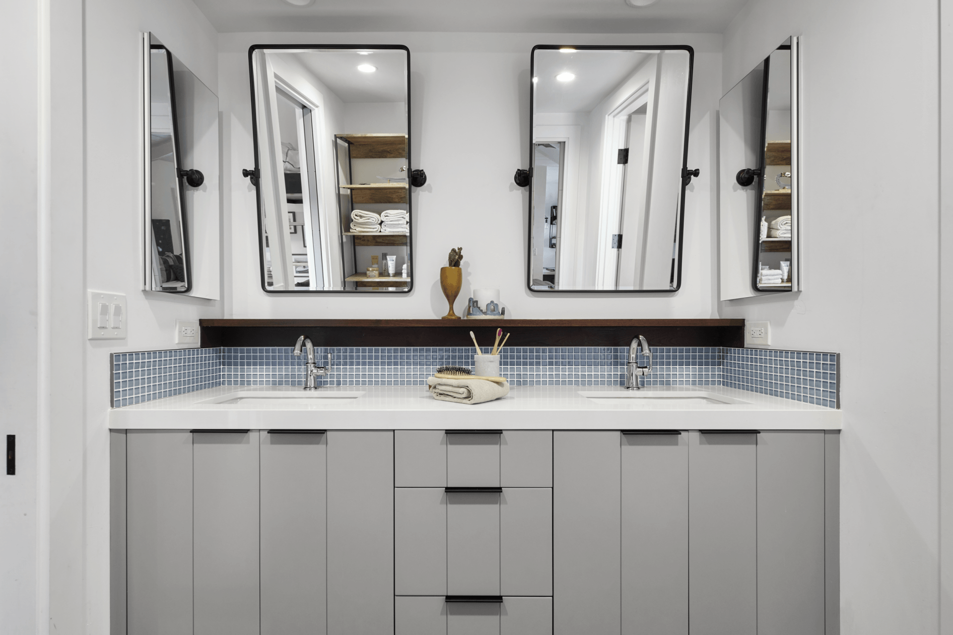 A bathroom with two sinks and two mirrors.
