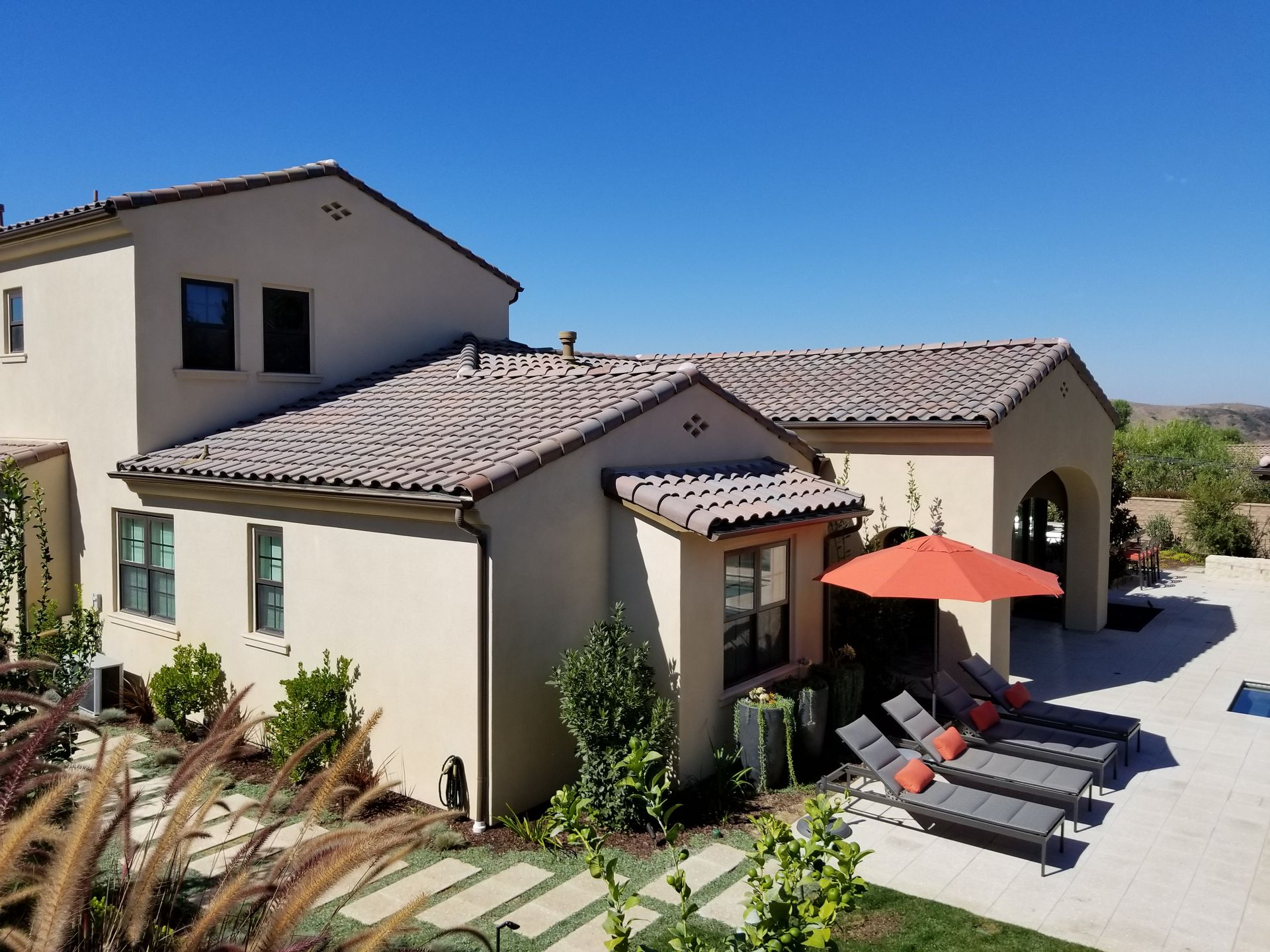 A large house with an orange umbrella in front of it