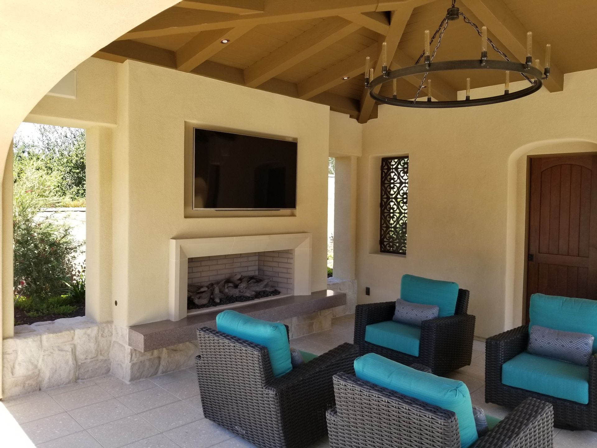A living room with wicker furniture and a fireplace