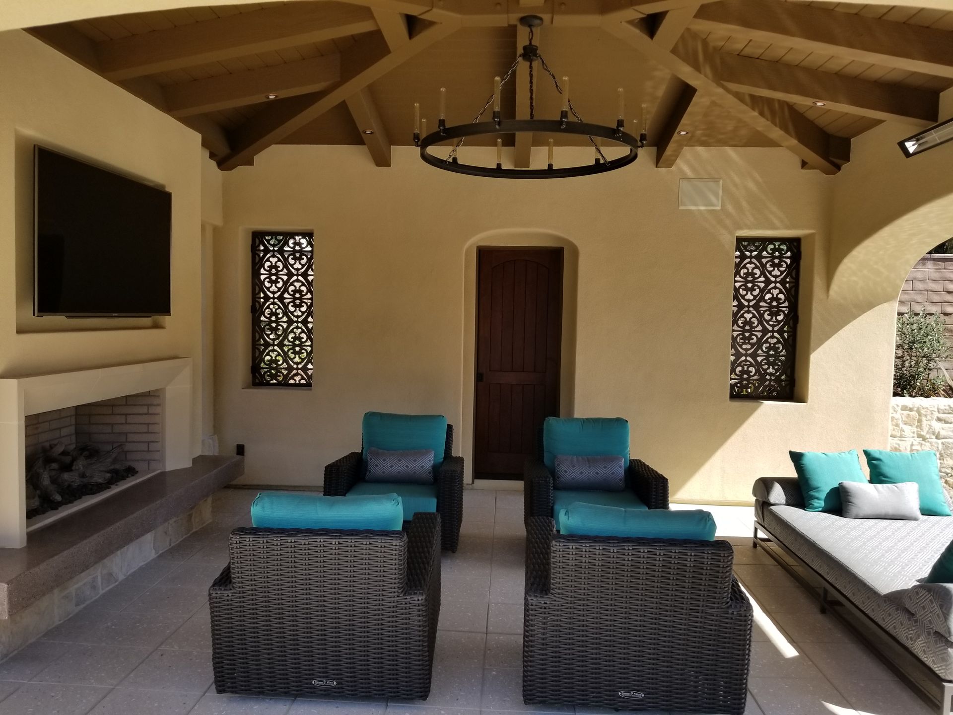 A living room with wicker furniture and a fireplace