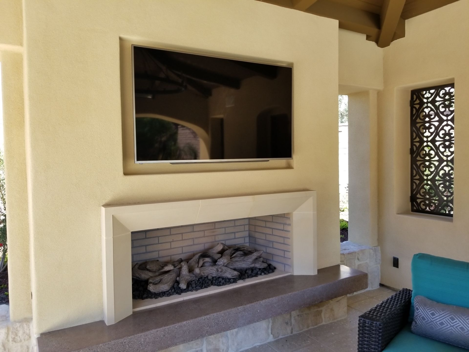 A fireplace with a flat screen tv mounted above it.