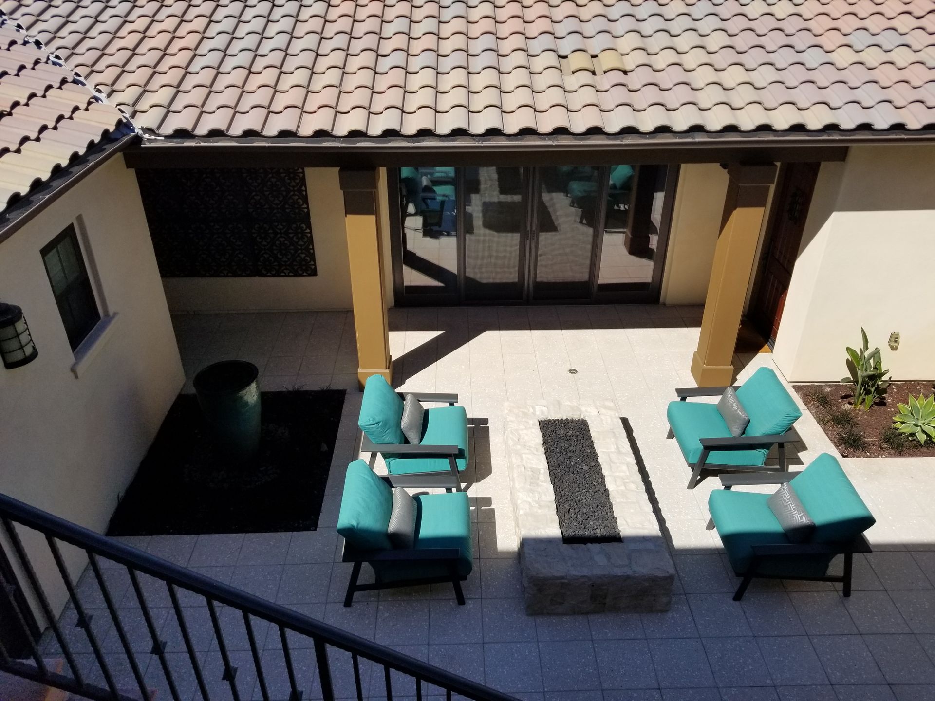 An aerial view of a patio with chairs and a fire pit