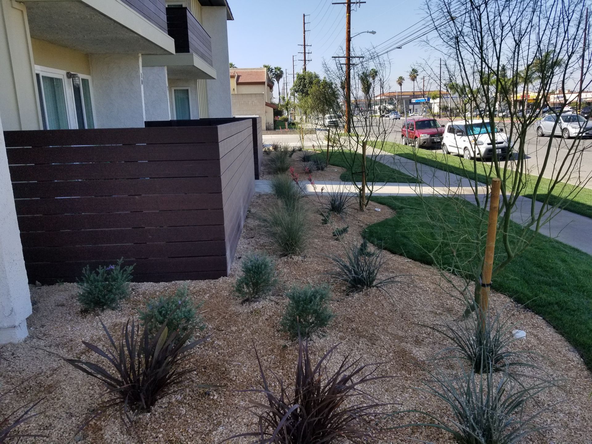 A fence with a lot of plants in front of a building