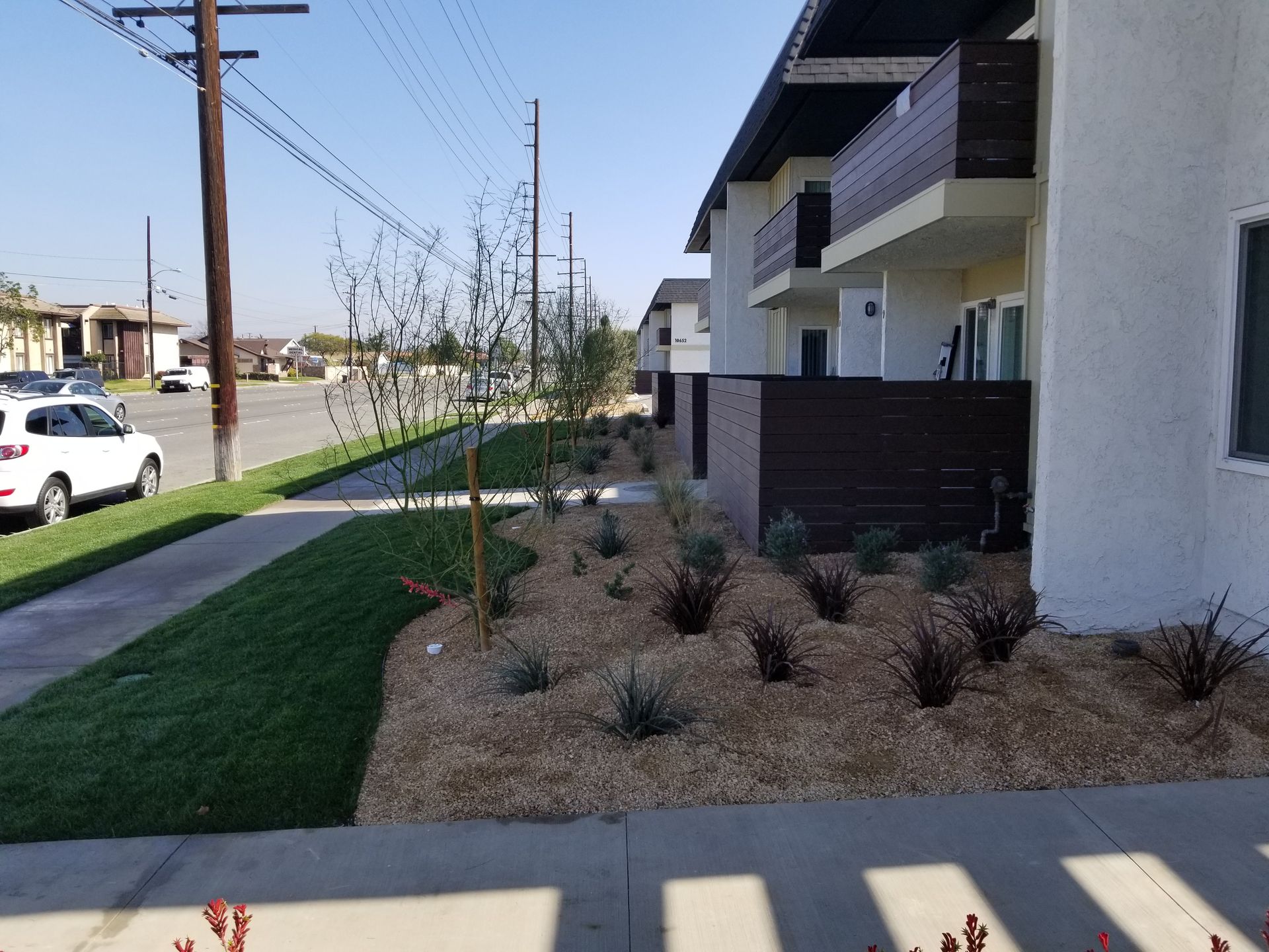 A white car is parked in front of a building