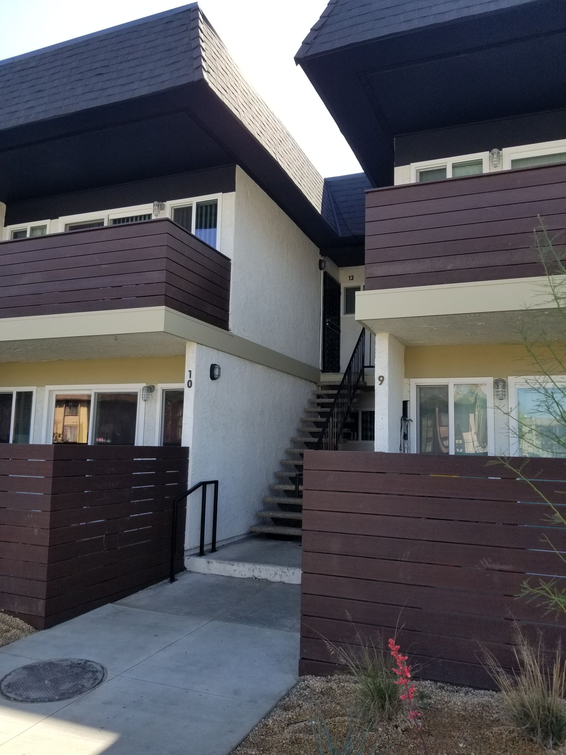 A building with stairs leading up to the second floor