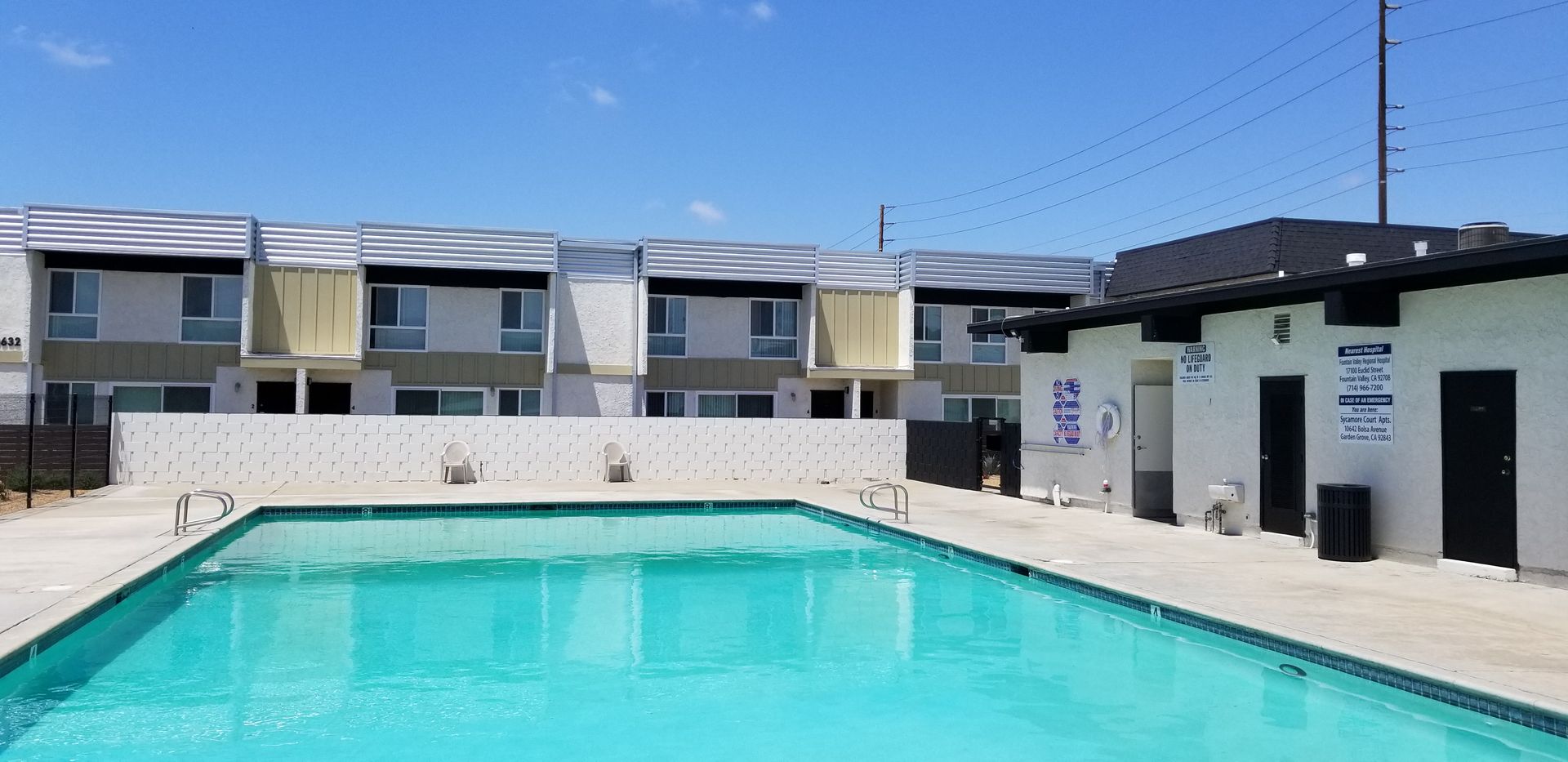 A large swimming pool is in front of a building.