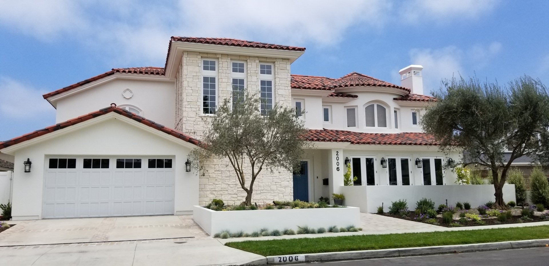 A large white house with a red tile roof