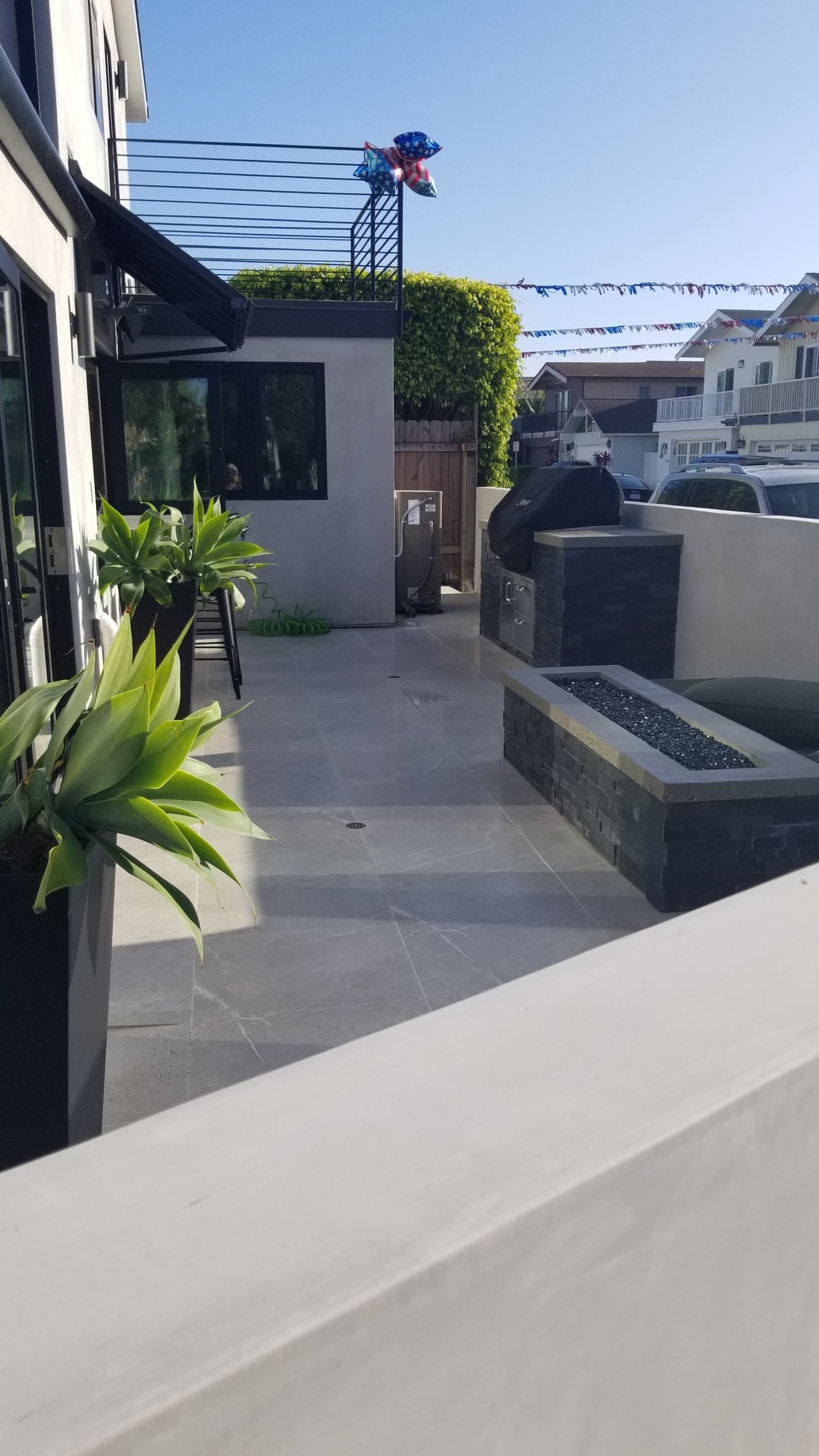 A walkway leading to a building with a fire pit in the middle of it.