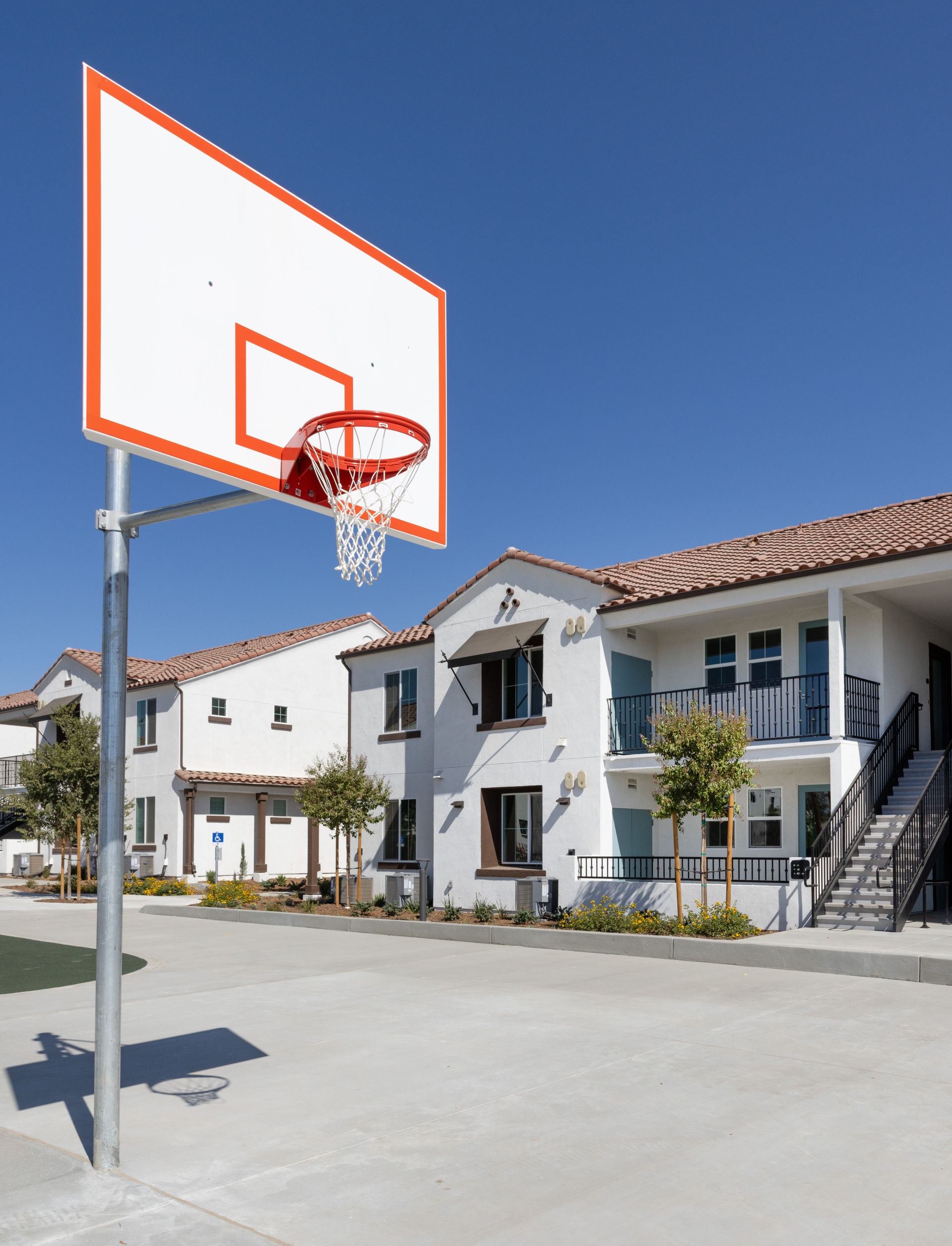 A basketball hoop in front of a white building