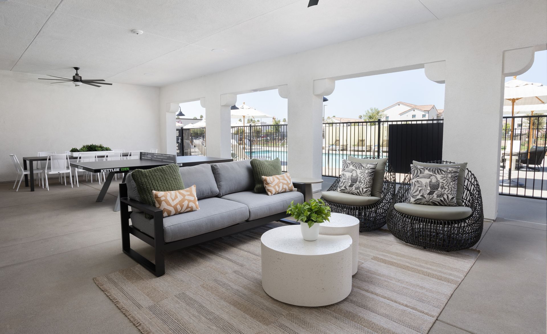 A living room with a couch , chairs and tables