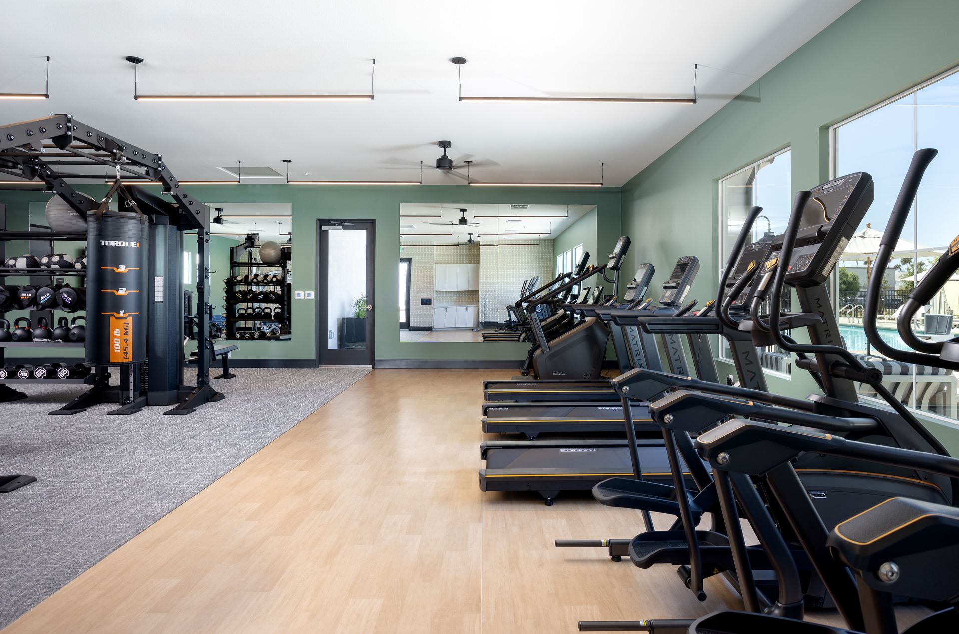 A large gym with a lot of treadmills and ellipticals.