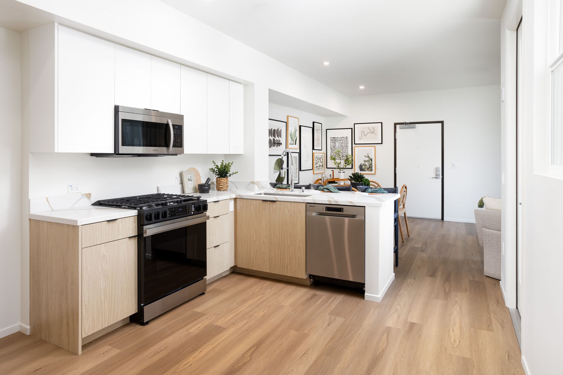 A kitchen with stainless steel appliances and wooden cabinets.