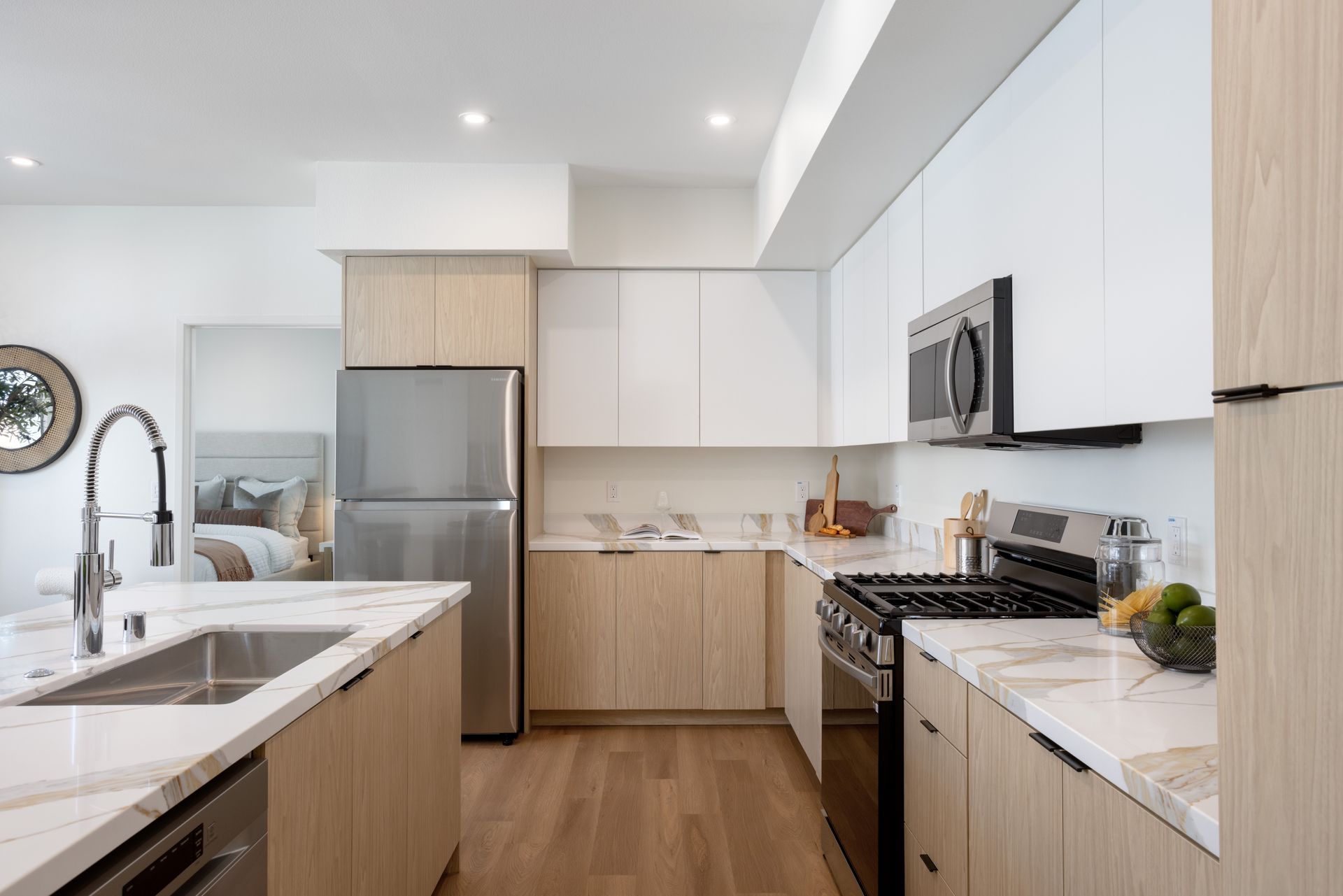 A kitchen with stainless steel appliances and wooden cabinets.