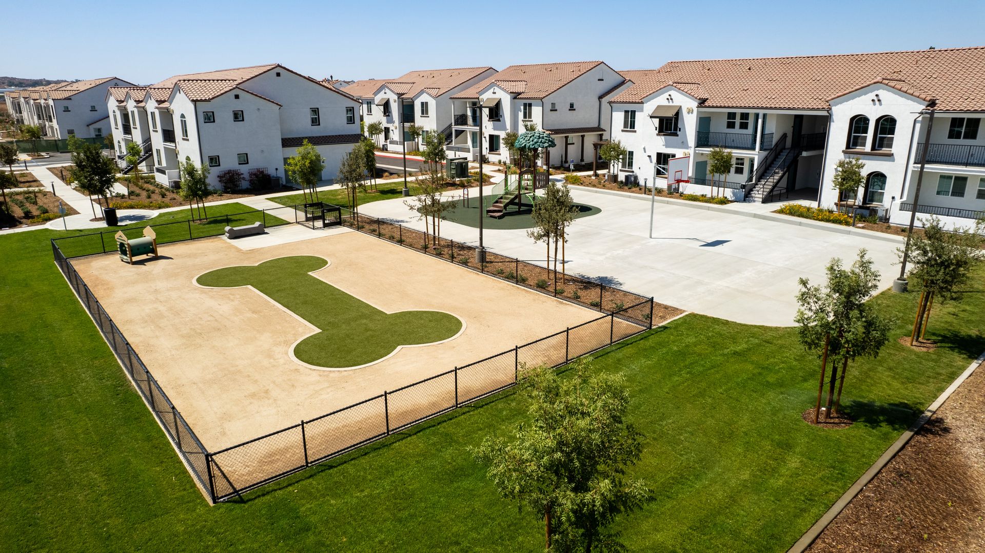 An aerial view of a dog park in a residential area