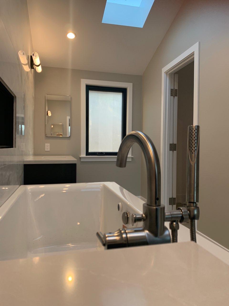 A bathroom with a bathtub and a shower head