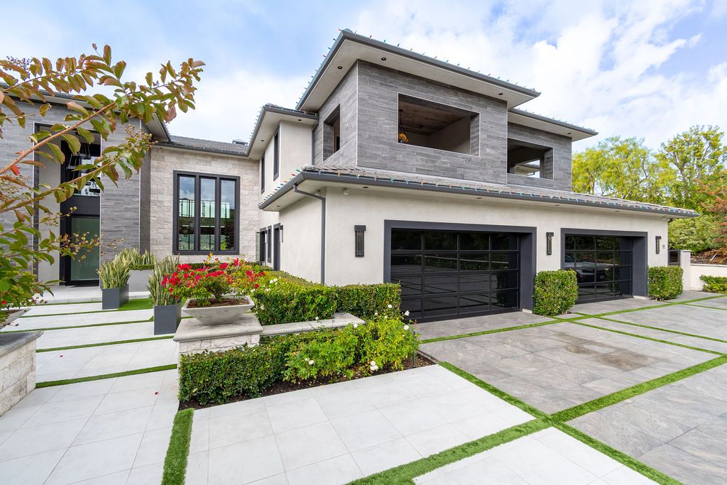 A large house with two garages and a driveway.