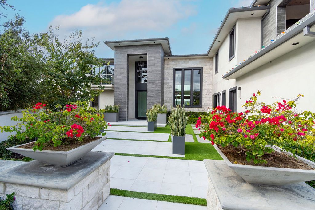 A large white house with flowers in front of it