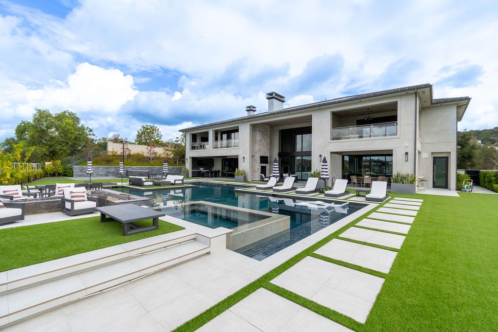 A large house with a large swimming pool in the backyard.