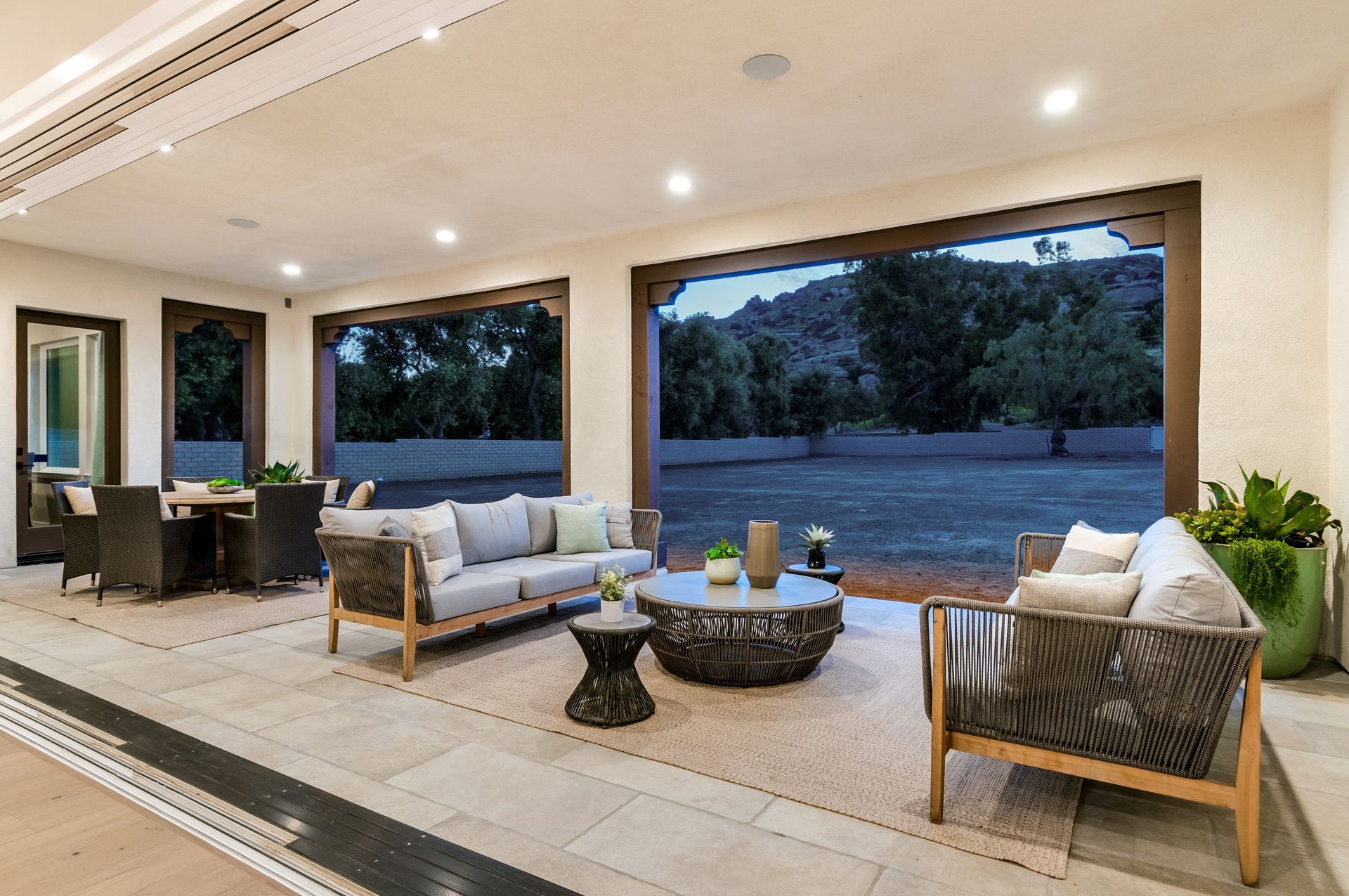 A living room with a couch , chairs , and a table.