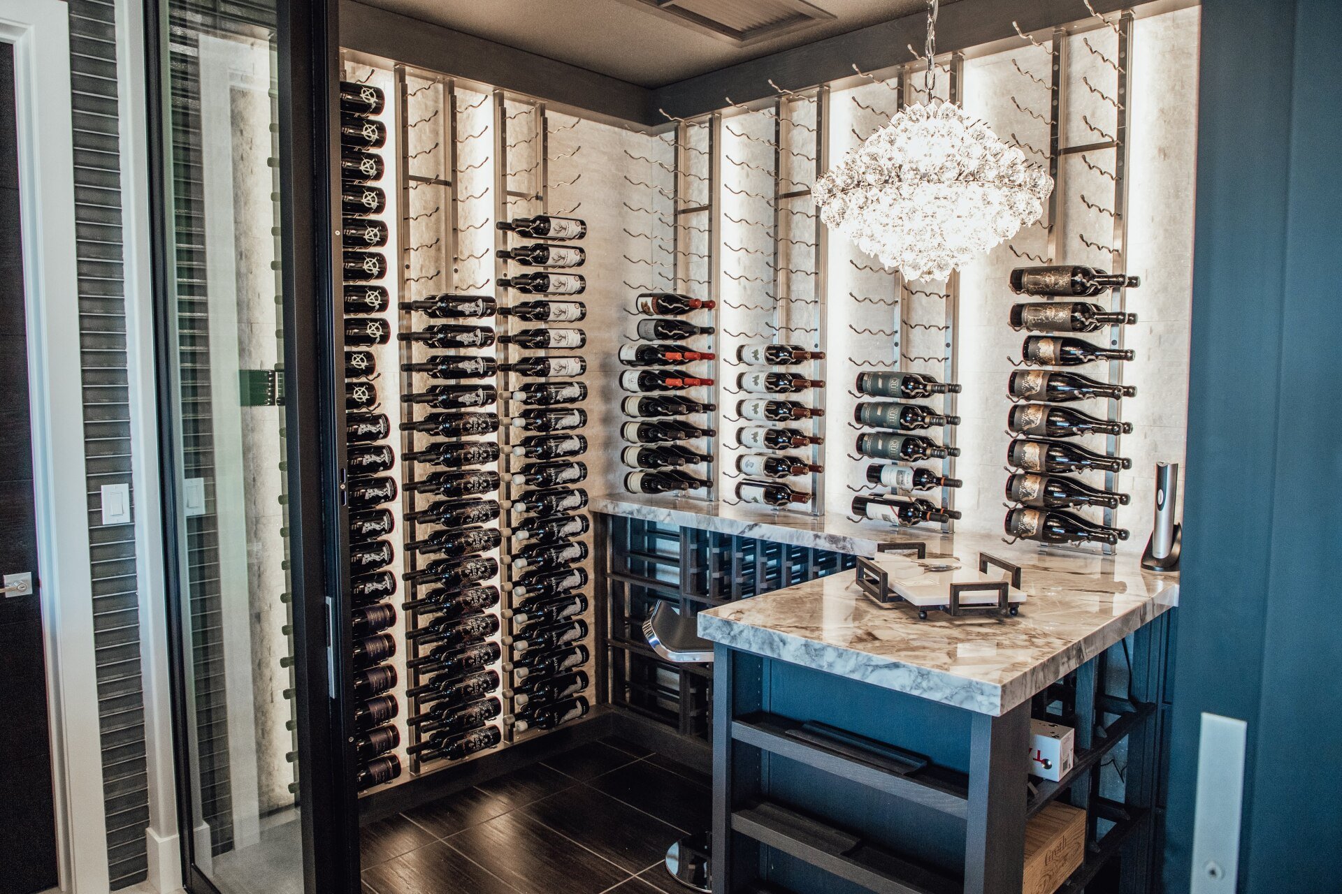 A wine cellar filled with lots of bottles of wine and a table.