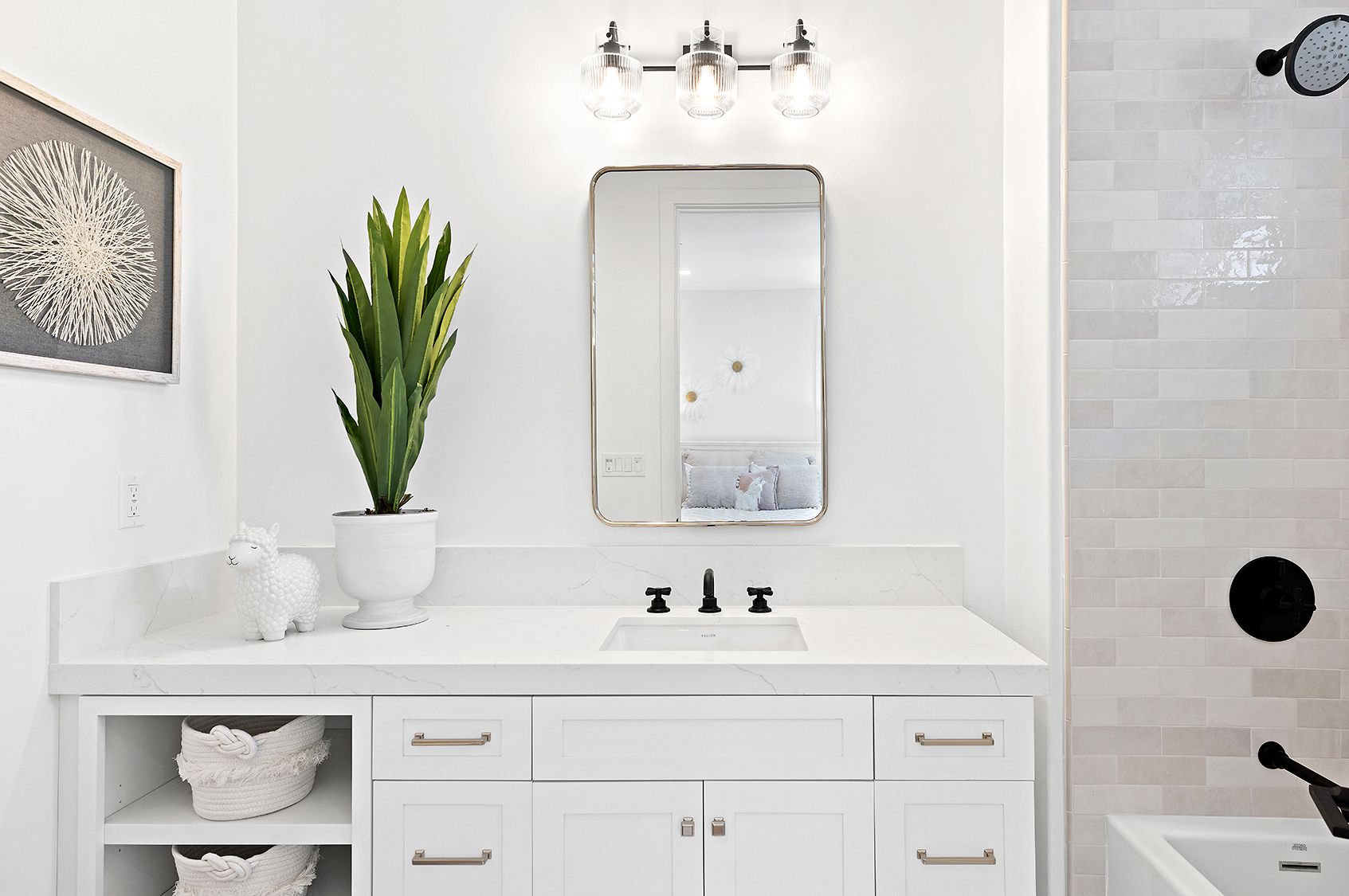A bathroom with a sink , mirror , and bathtub.