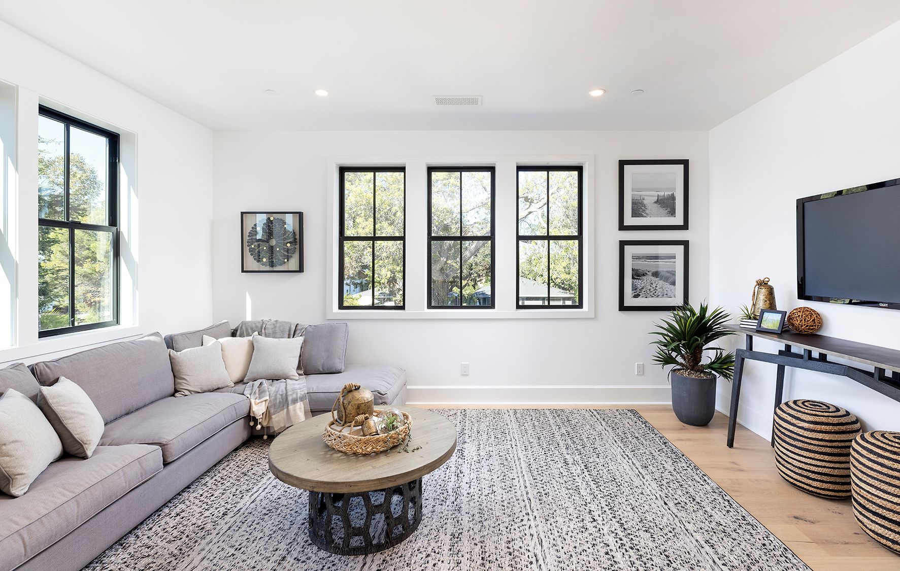 A living room with a couch , coffee table , and television.