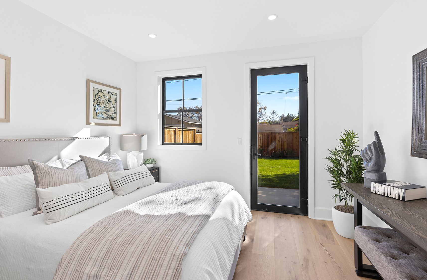 A bedroom with a large bed and a sliding glass door leading to a patio.